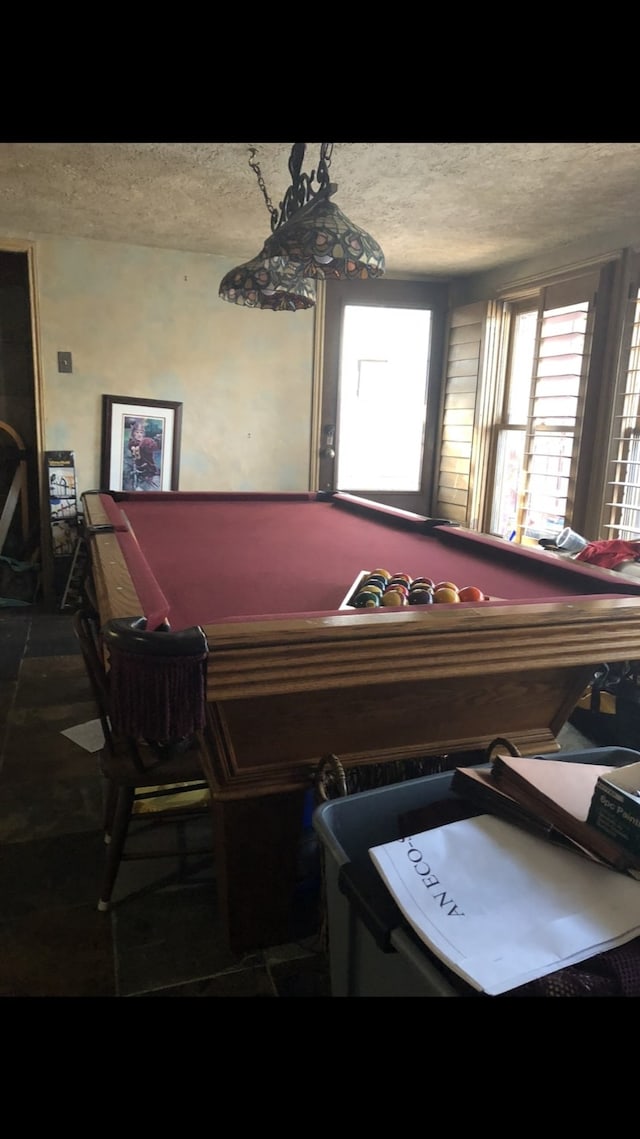 rec room featuring tile patterned floors, a textured ceiling, and billiards