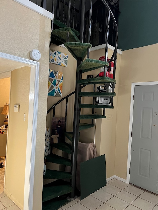 stairway with tile patterned floors