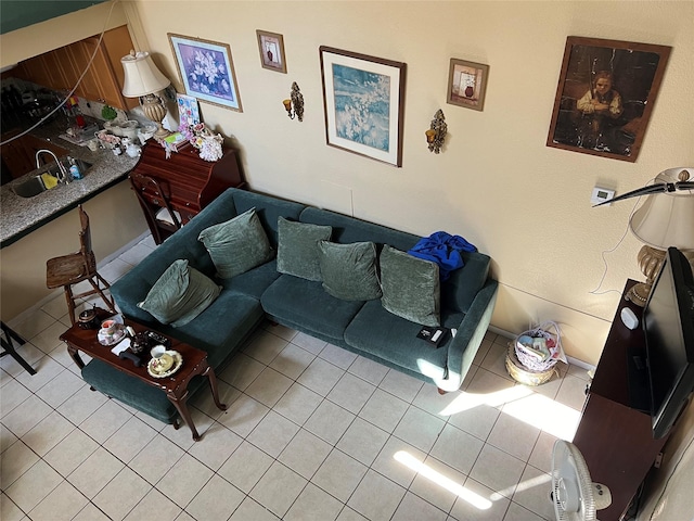 living room with light tile patterned floors and sink