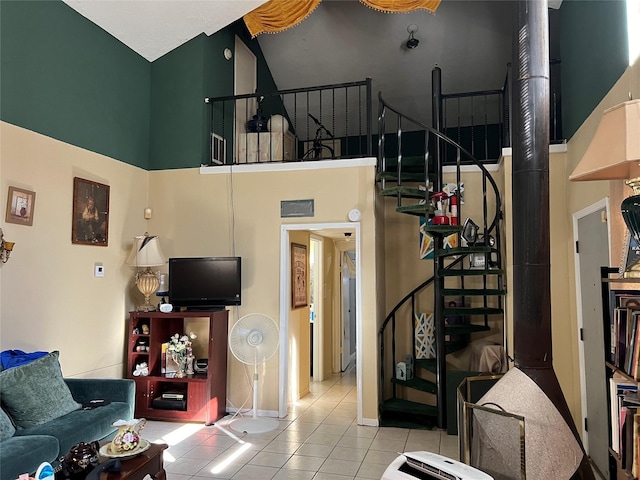 living room featuring light tile patterned flooring and a high ceiling