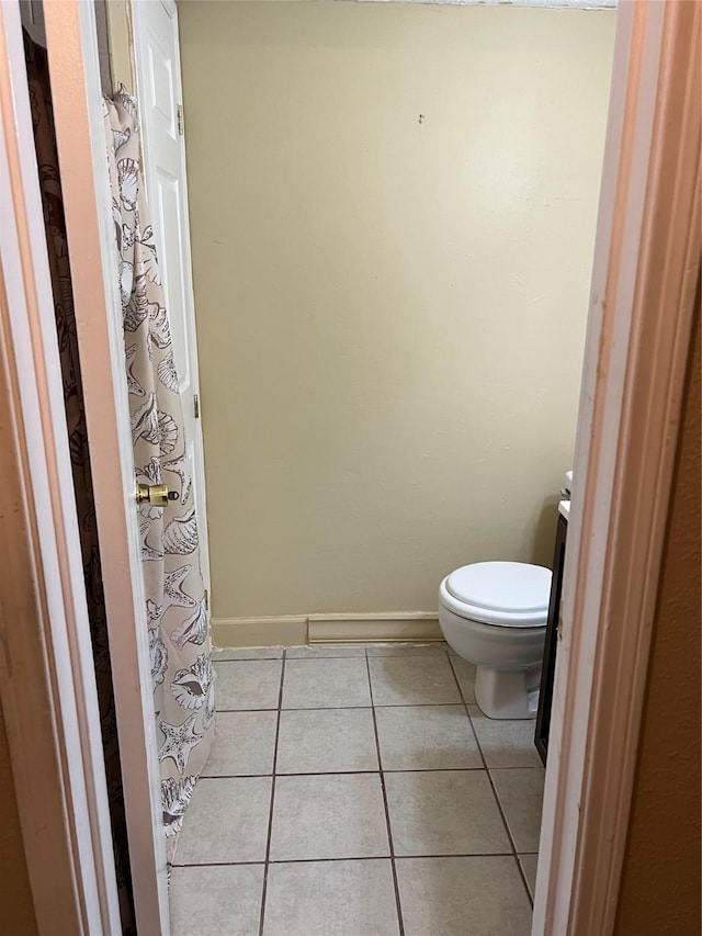 bathroom with tile patterned flooring, vanity, and toilet