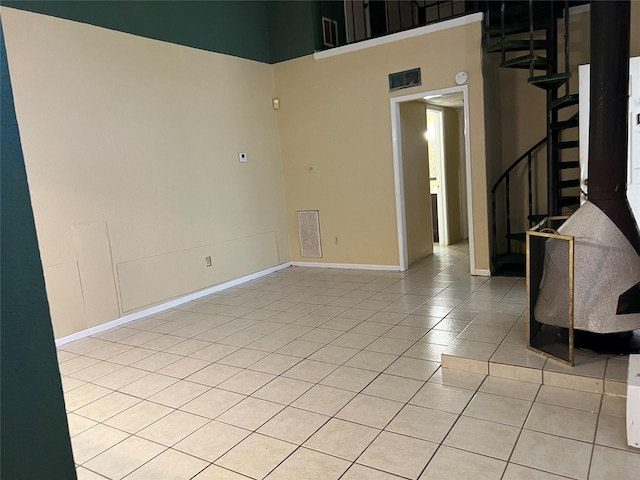 tiled empty room with a high ceiling