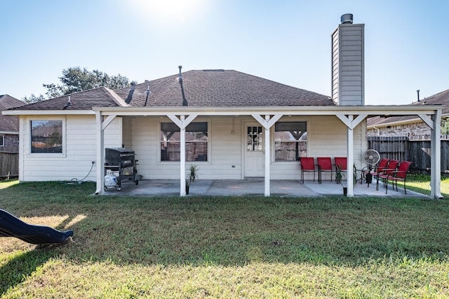 back of property featuring a yard and a patio