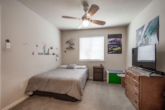 bedroom with light carpet, a textured ceiling, and ceiling fan