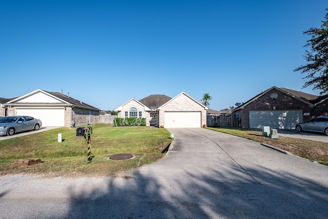 ranch-style house featuring a garage and a front lawn