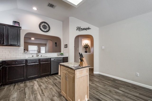 kitchen featuring tasteful backsplash, sink, dark wood-type flooring, and stainless steel dishwasher