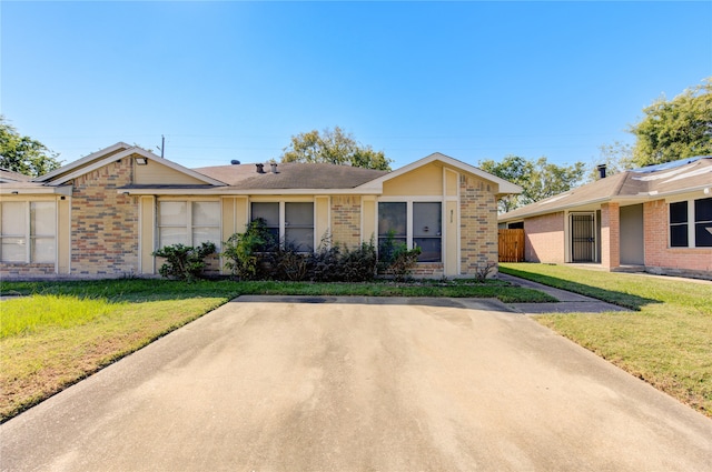 ranch-style house with a front lawn