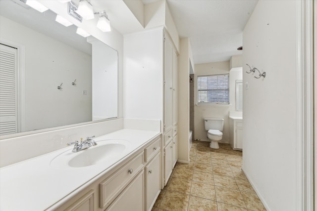 bathroom featuring tile patterned flooring, vanity, and toilet