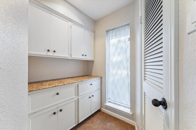 914 Forest Lake Dr, Seabrook, TX 77586 - interior space with white cabinetry, tile patterned floors, and light stone countertops