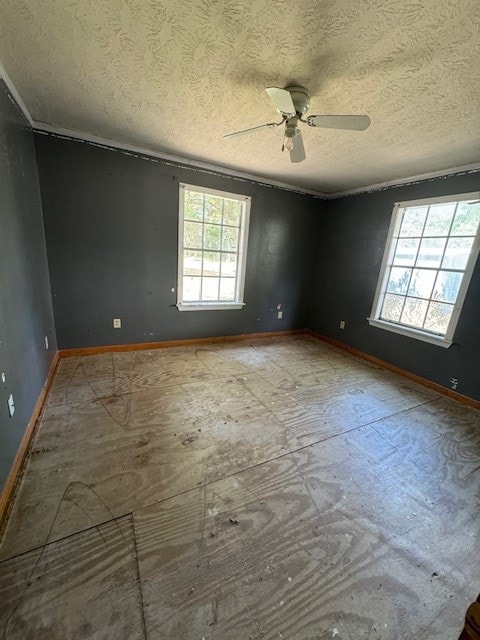 empty room featuring ceiling fan, crown molding, and a textured ceiling