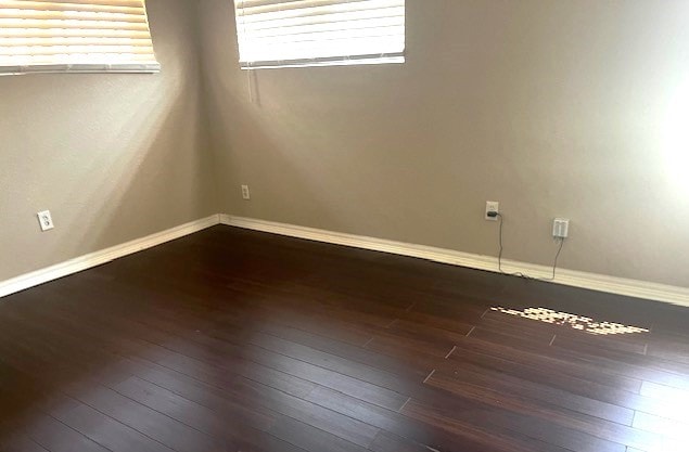 unfurnished room featuring dark hardwood / wood-style floors