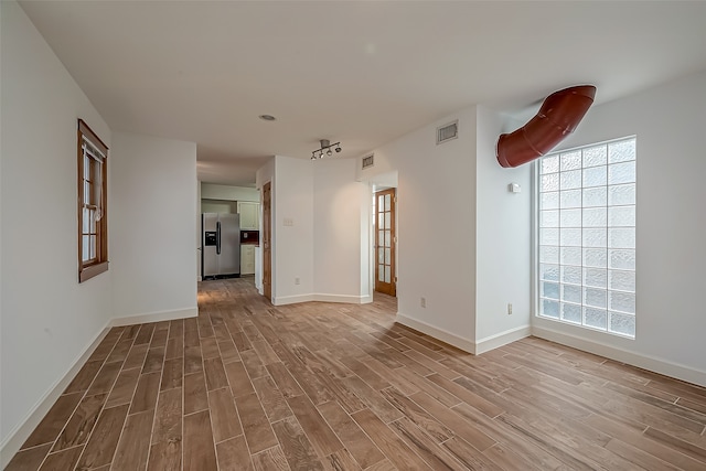 unfurnished room featuring light hardwood / wood-style floors