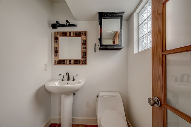 bathroom featuring toilet and sink