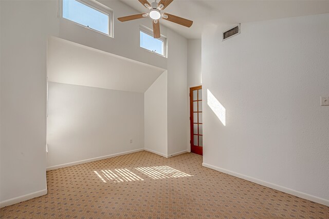 bonus room featuring light colored carpet and ceiling fan