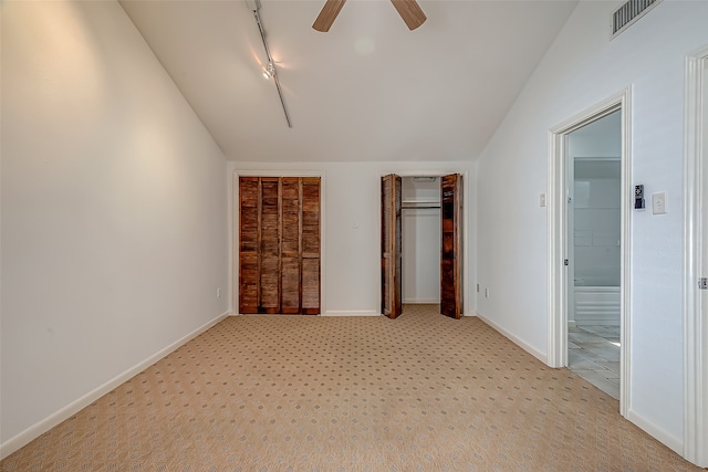 unfurnished bedroom featuring light carpet, lofted ceiling, and ceiling fan