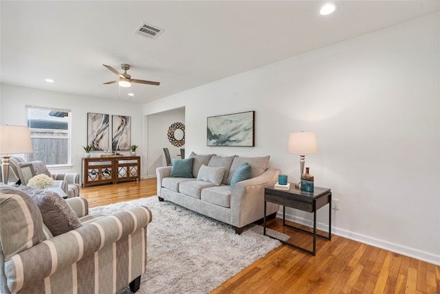 living room featuring ceiling fan and hardwood / wood-style floors