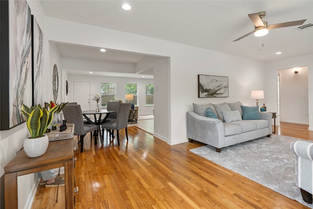 living room with hardwood / wood-style floors and ceiling fan