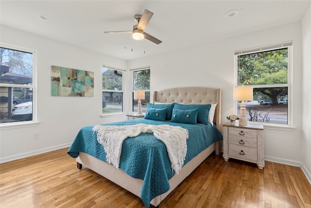 bedroom with ceiling fan and hardwood / wood-style flooring