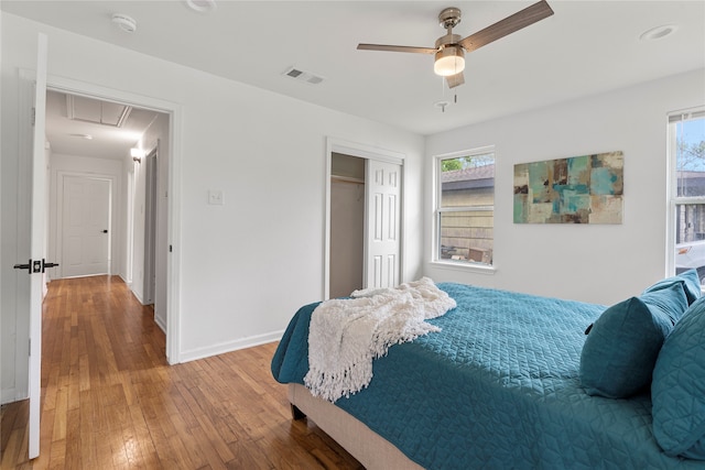 bedroom featuring hardwood / wood-style flooring, a closet, and ceiling fan