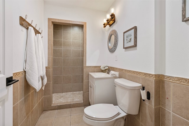 bathroom with tile patterned floors, tile walls, toilet, and vanity