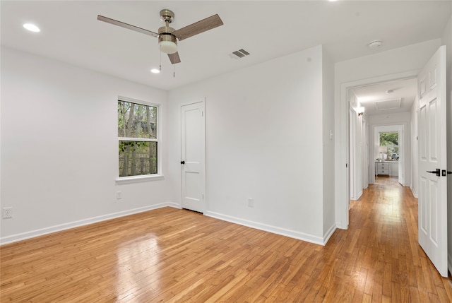 empty room with light wood-type flooring and ceiling fan