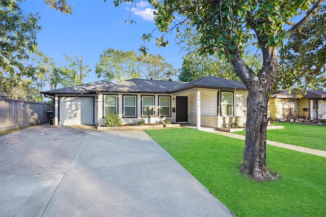 ranch-style home with a garage and a front lawn