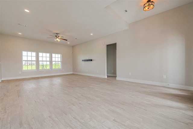 empty room featuring ceiling fan and light hardwood / wood-style floors