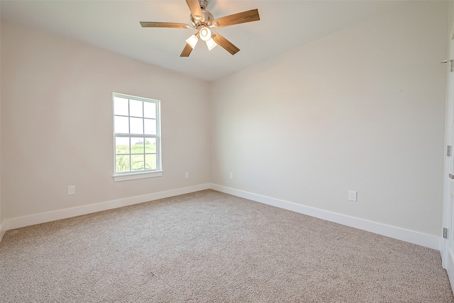 carpeted empty room featuring ceiling fan