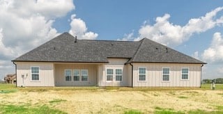 back of house with a lawn