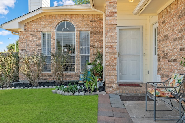 doorway to property featuring a lawn