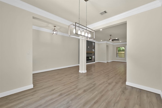 unfurnished living room with ornamental molding, hardwood / wood-style flooring, and ceiling fan