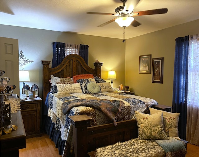 bedroom with light hardwood / wood-style flooring and ceiling fan