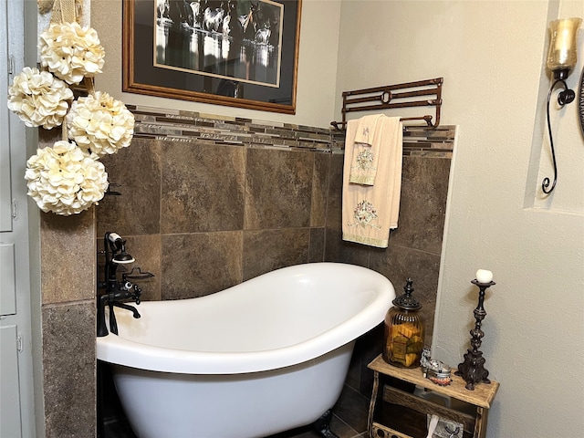 bathroom with tile walls and a tub