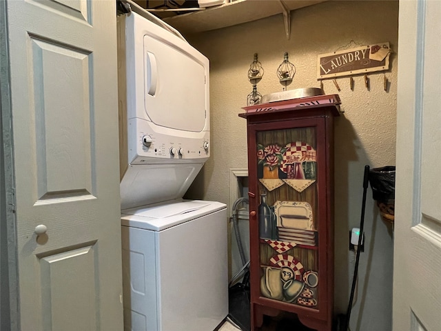 washroom featuring stacked washer / dryer