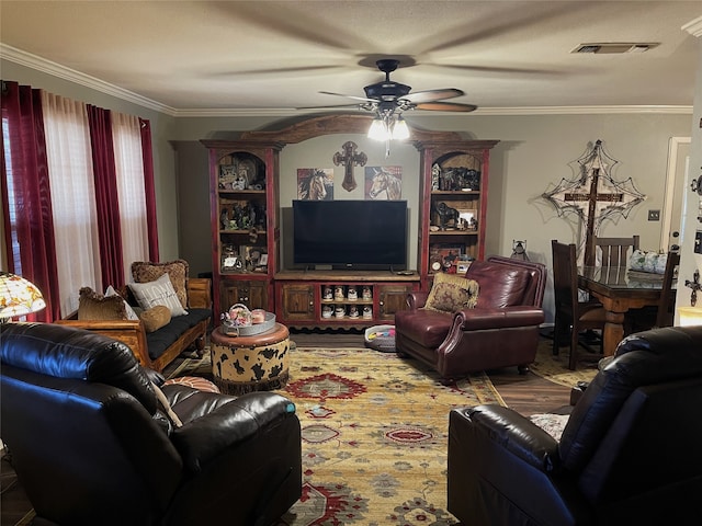 living room with ornamental molding and ceiling fan