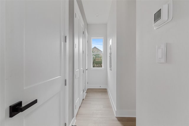 corridor with light hardwood / wood-style flooring