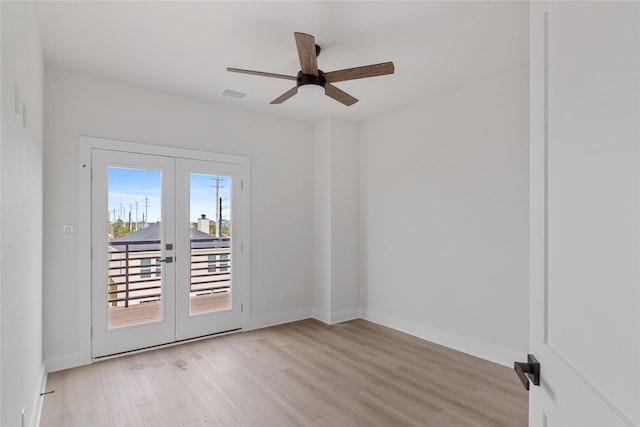 spare room featuring french doors, light wood-type flooring, and ceiling fan