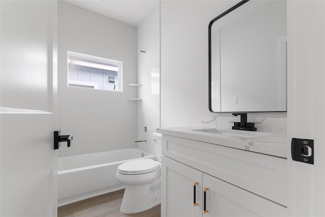 full bathroom featuring hardwood / wood-style floors, vanity, toilet, and bathtub / shower combination