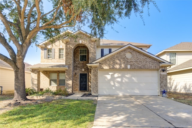 view of front of property featuring a front lawn and a garage