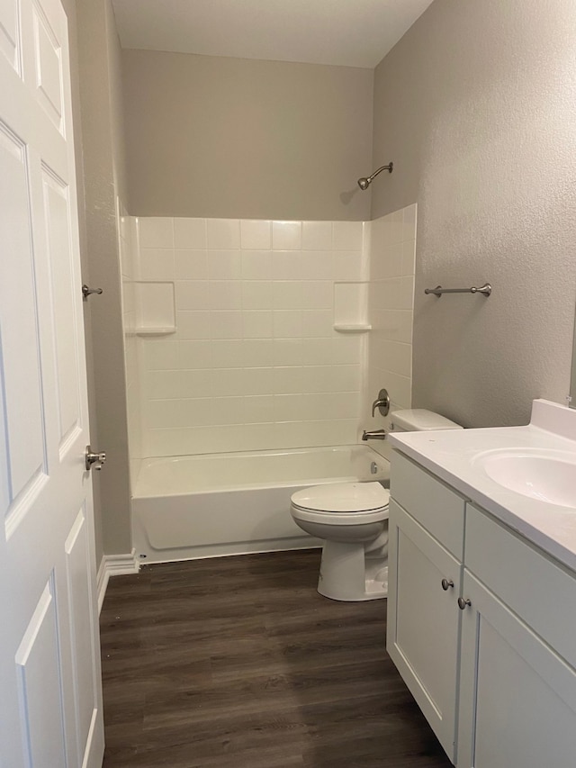 full bathroom featuring vanity, hardwood / wood-style floors, bathing tub / shower combination, and toilet