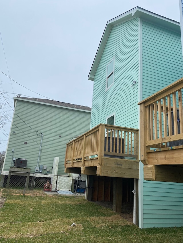 view of property exterior featuring a deck and a lawn