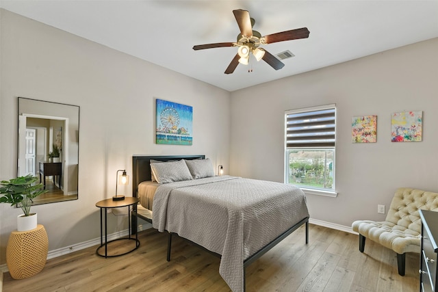 bedroom with light wood-type flooring and ceiling fan