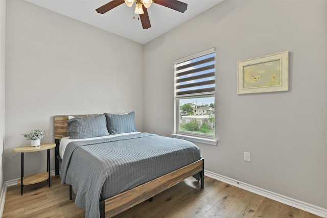 bedroom featuring ceiling fan and light hardwood / wood-style flooring