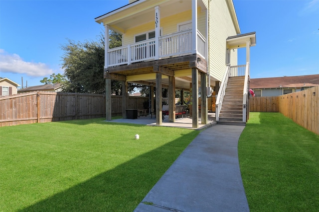 rear view of house with a yard and a patio area