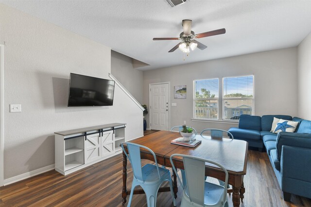 dining room with ceiling fan and dark hardwood / wood-style flooring