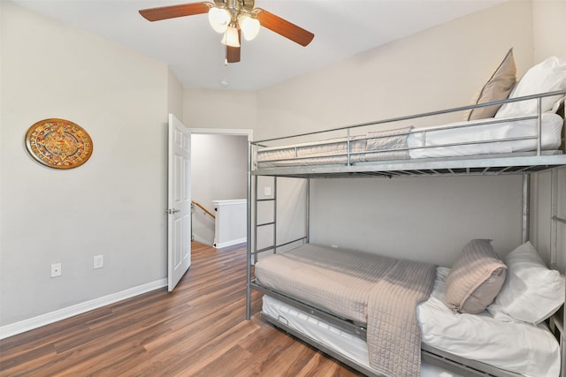 bedroom with ceiling fan and dark wood-type flooring