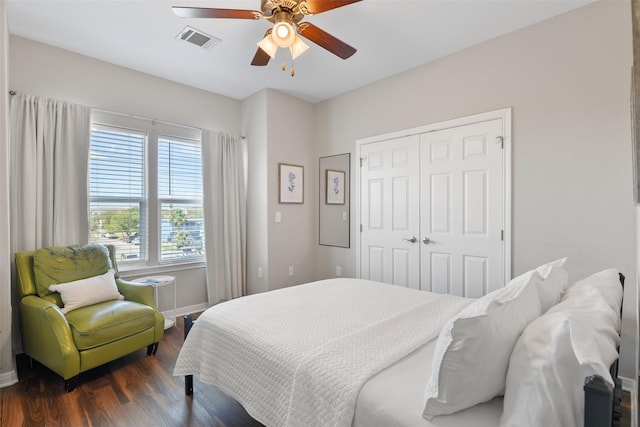 bedroom with a closet, ceiling fan, and dark wood-type flooring