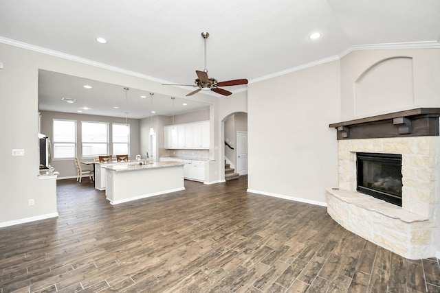 kitchen featuring a kitchen island with sink, dark hardwood / wood-style flooring, white cabinets, and pendant lighting