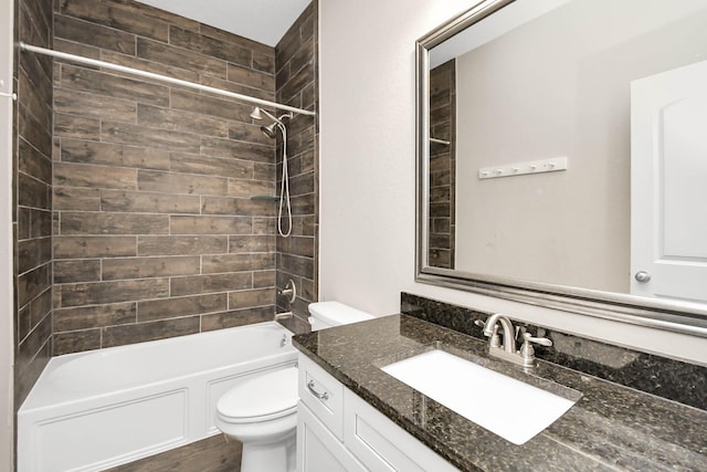 full bathroom with vanity, toilet, and tiled shower / bath