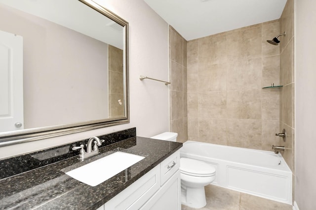 full bathroom with tile patterned flooring, vanity, tiled shower / bath combo, and toilet